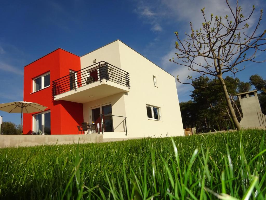 a house with a red and white at Villa Anita Kožino in Kožino