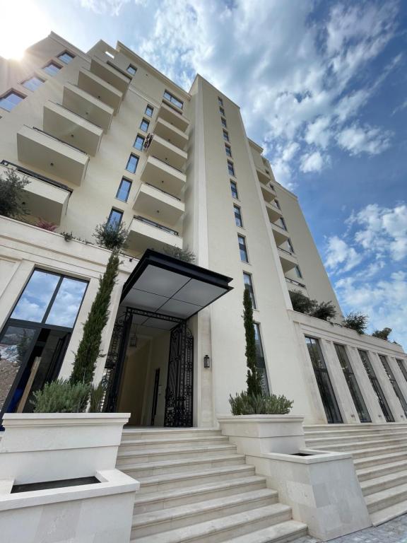 a white building with stairs in front of it at Lasadu Studio in Casa Al Mare, 2 min to Beach in Bečići
