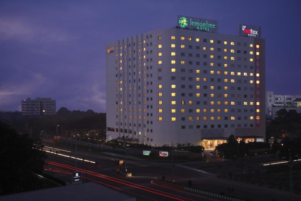oświetlony budynek z znakiem na górze w obiekcie Lemon Tree Premier Hitec City Hyderabad w mieście Hajdarabad