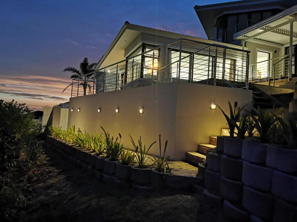 a house with lights on the side of it at Nearby Herolds Bay Self-Catering Guest House in Herolds Bay