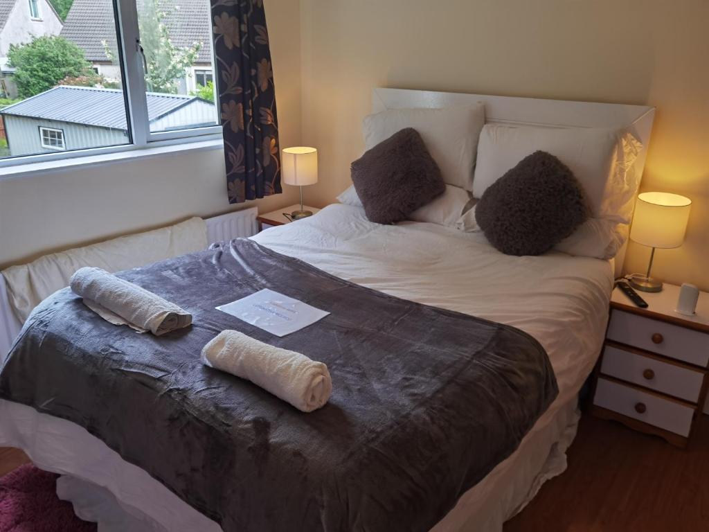 a bedroom with a bed with two pillows on it at TravelMore in Letterkenny