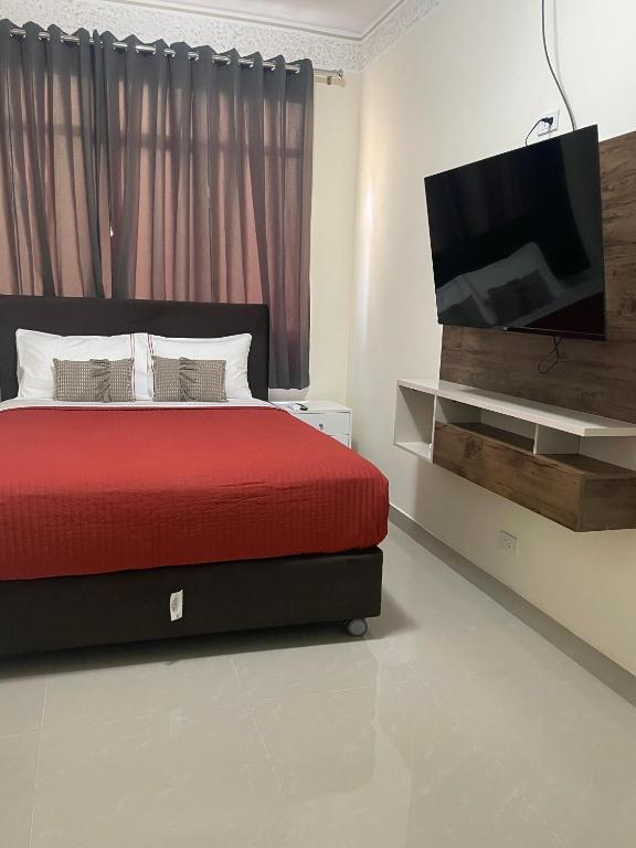 Rúm í herbergi á Hotel Calmelia