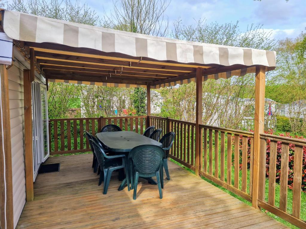 d'une terrasse avec une table et des chaises. dans l'établissement Hebergement dans un Domaine à Litteau, à Litteau