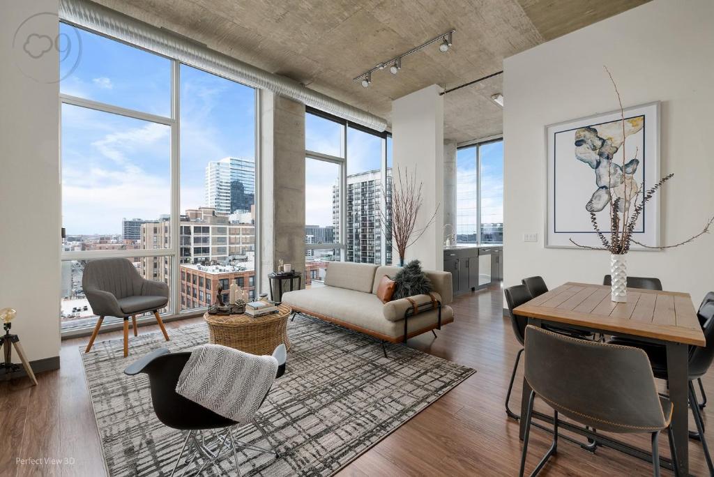 a living room with a couch and chairs and windows at Jeffjack Heated Pool Penthouse in Chicago's West Loop in Chicago