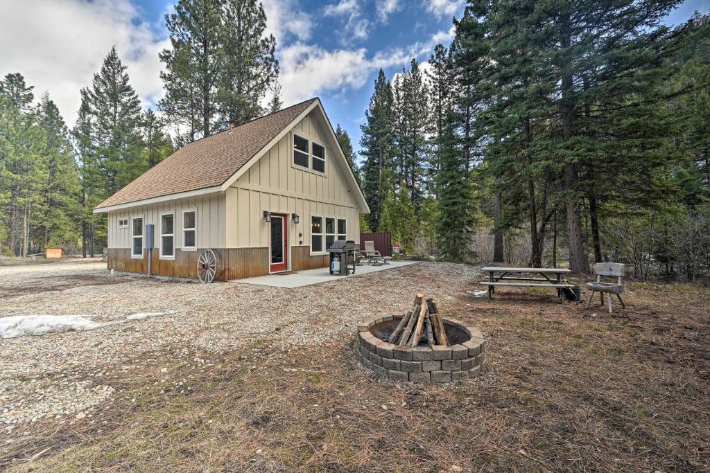 a barn with a fire pit in front of it at Darby Cabin in National Forest Walk to River! in Darby