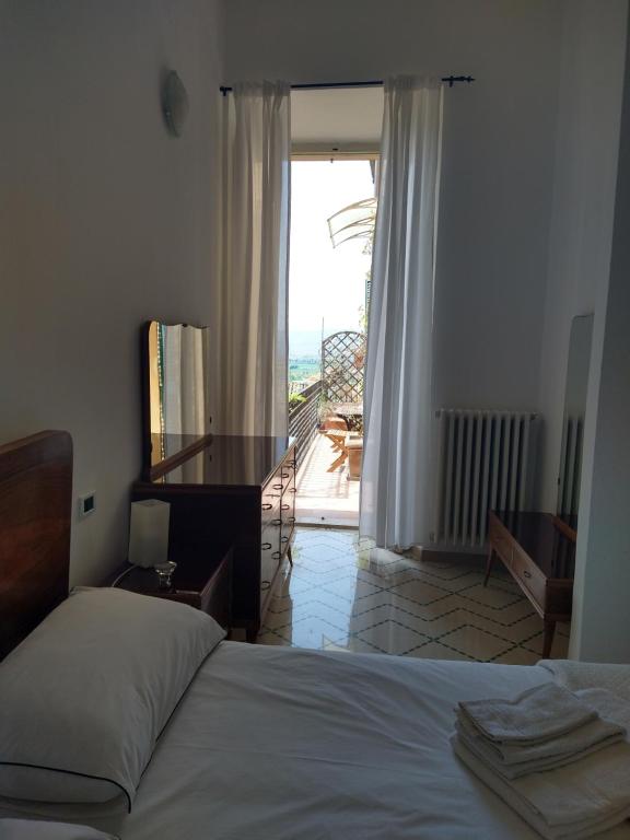 A bed or beds in a room at Maddalena House