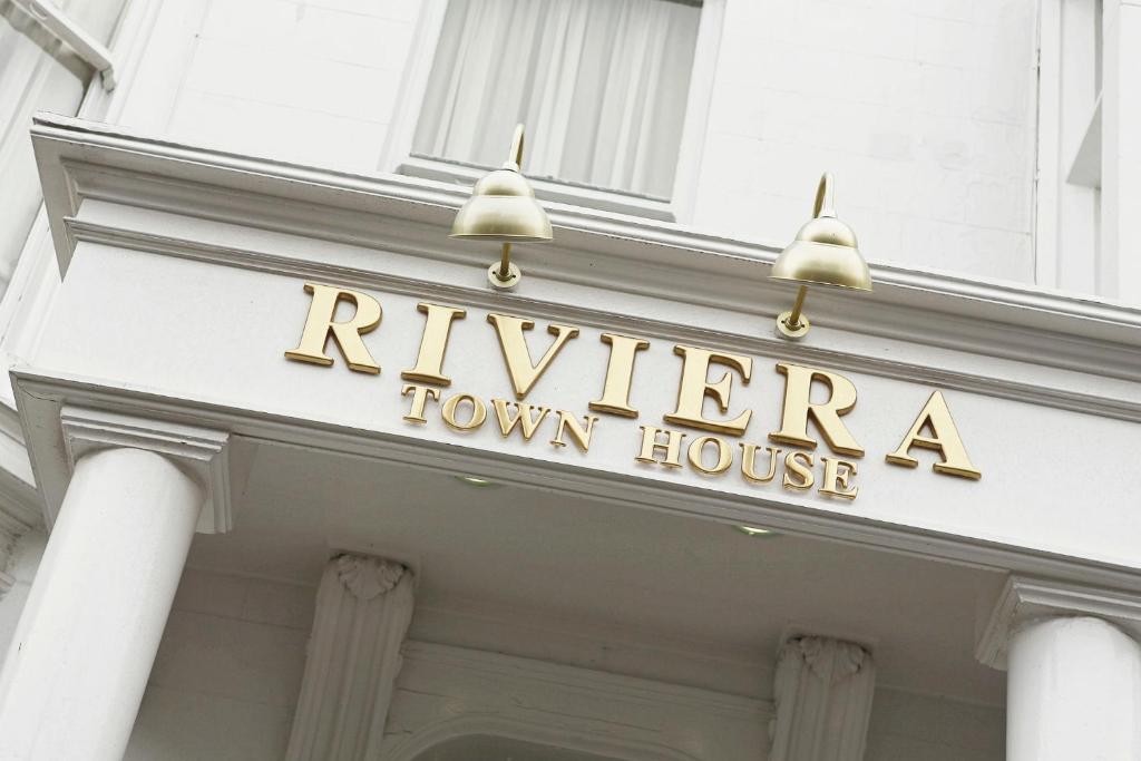a hotel sign on the front of a town house at Riviera Town House in Scarborough
