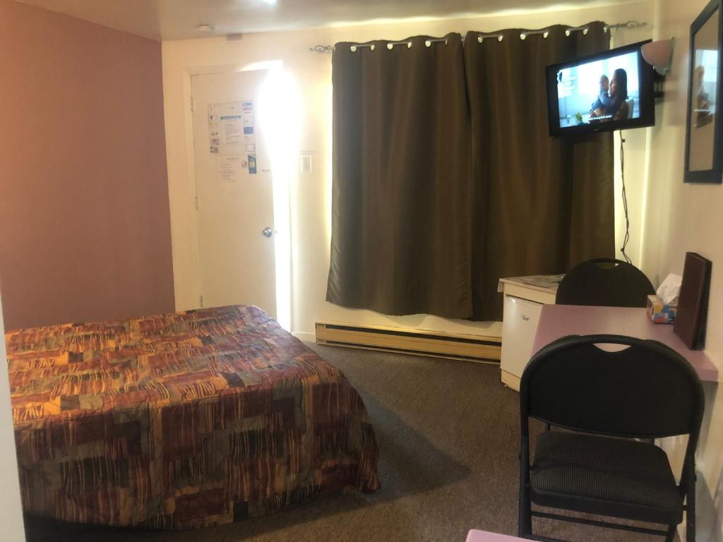 Postel nebo postele na pokoji v ubytování Motel Le Voyageur