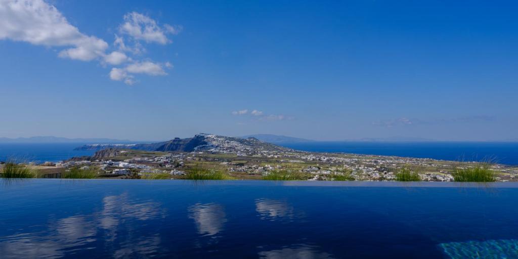 a view of a lake with a mountain in the background at Apikia Santorini in Pirgos