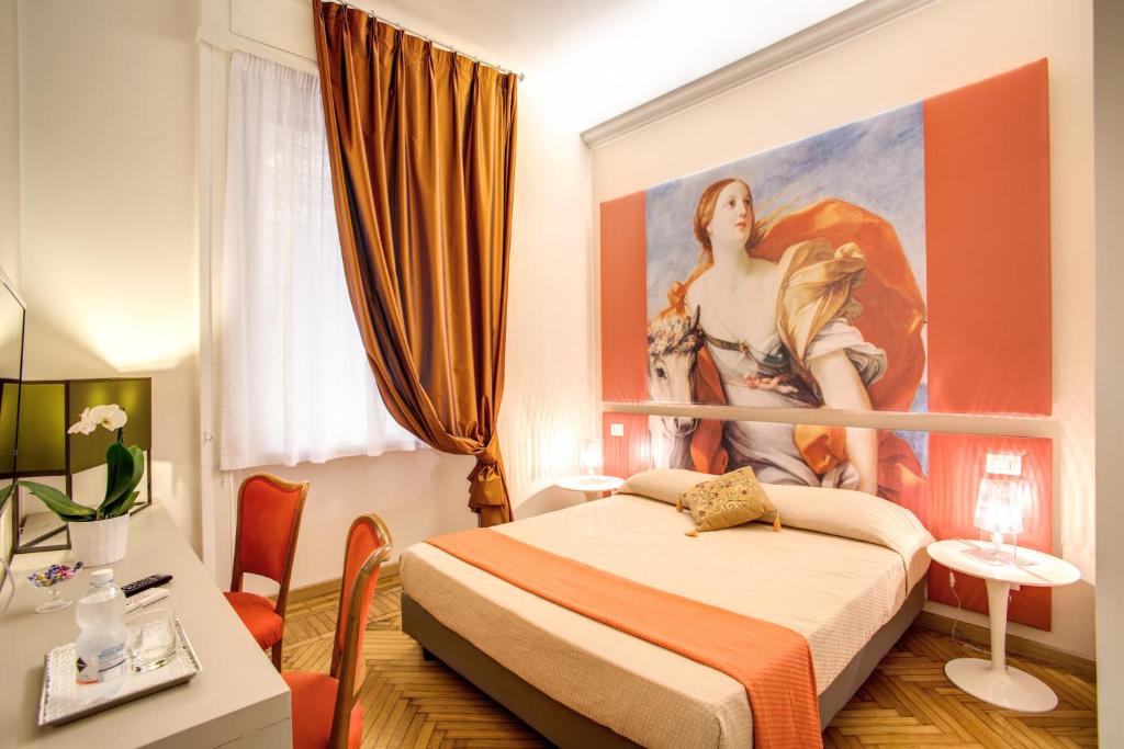 a bedroom with a painting of a woman on the wall at Roma In Una Stanza Guesthouse in Rome