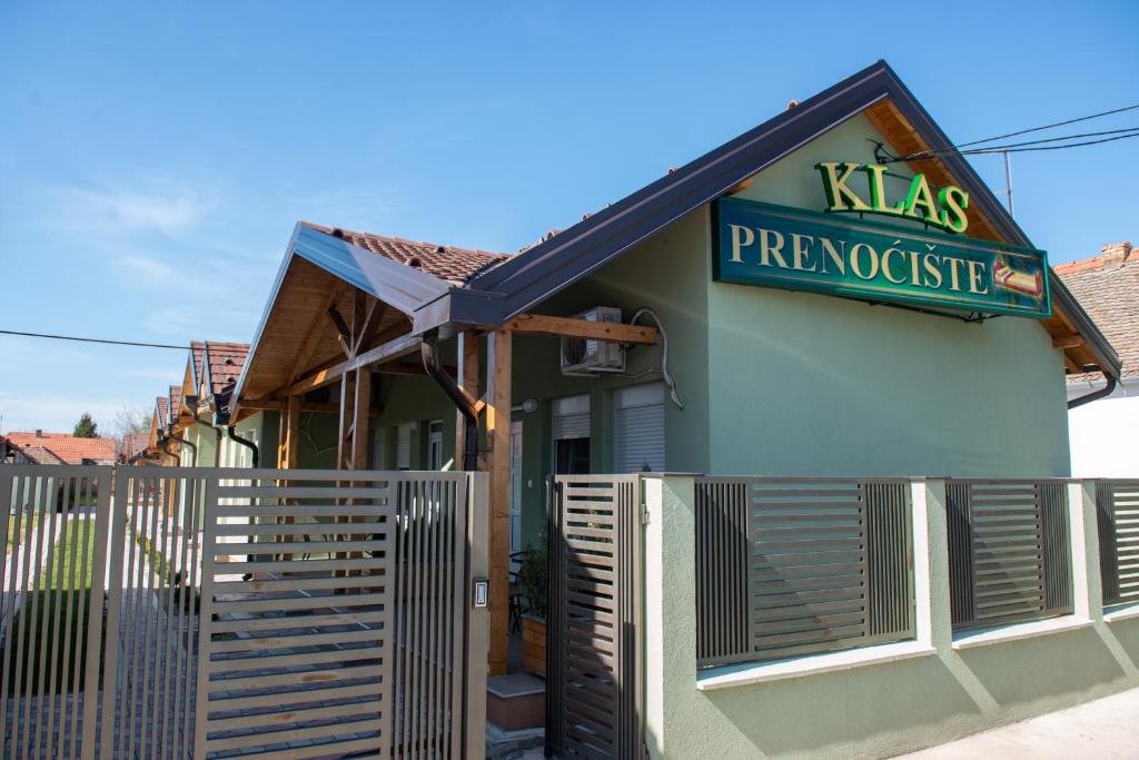 a restaurant with a sign on the side of a building at Zlatni Klas in Zrenjanin