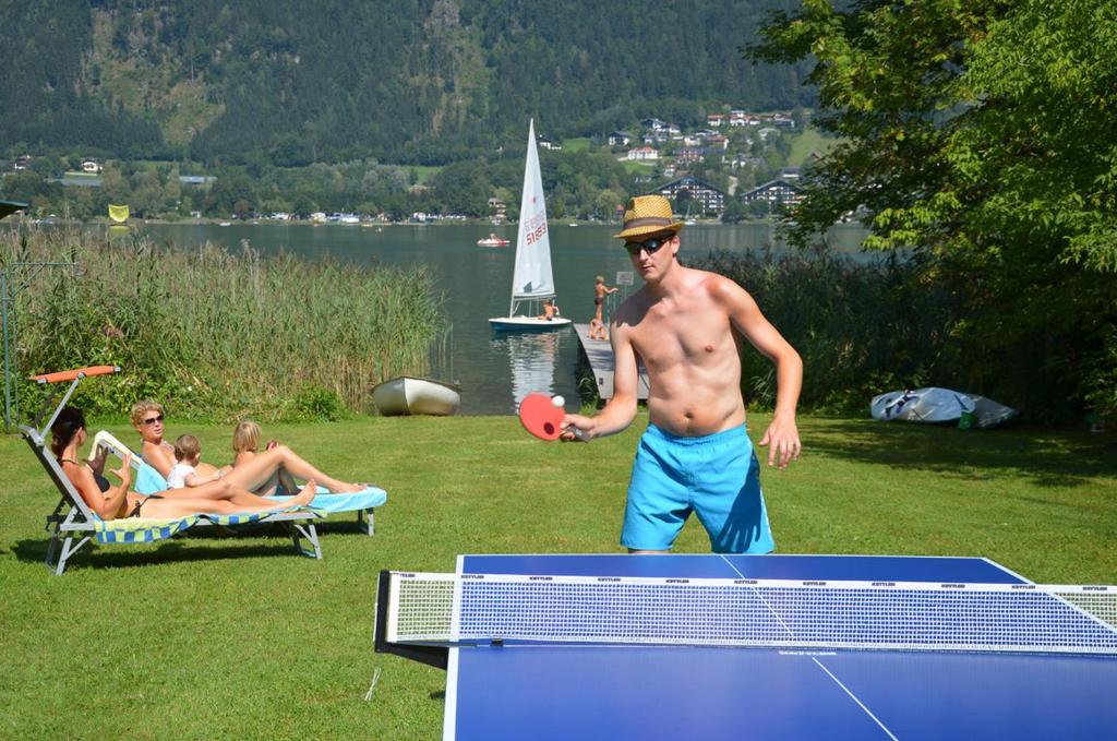 a shirtless man playing a game of table tennis at Villa Müller Turmfalke in Ossiach