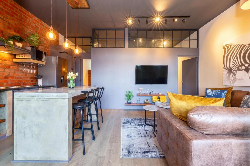 a living room with a bar and a couch at 10 Oyster Walk in Knysna