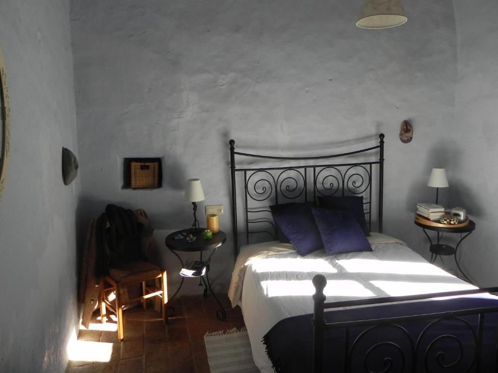 a bedroom with a large bed with purple pillows at BAIX EMPORDÀ. Increíble casa en pueblo medieval in Cruïlles