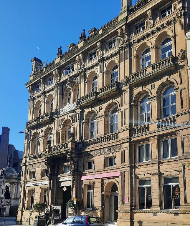 a large building with a car parked in front of it at 62 Castle Street Hotel in Liverpool