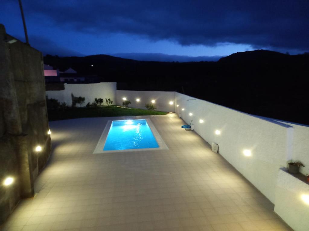 a house with a swimming pool at night at Cantinho do Pensamento in Ribeira Grande