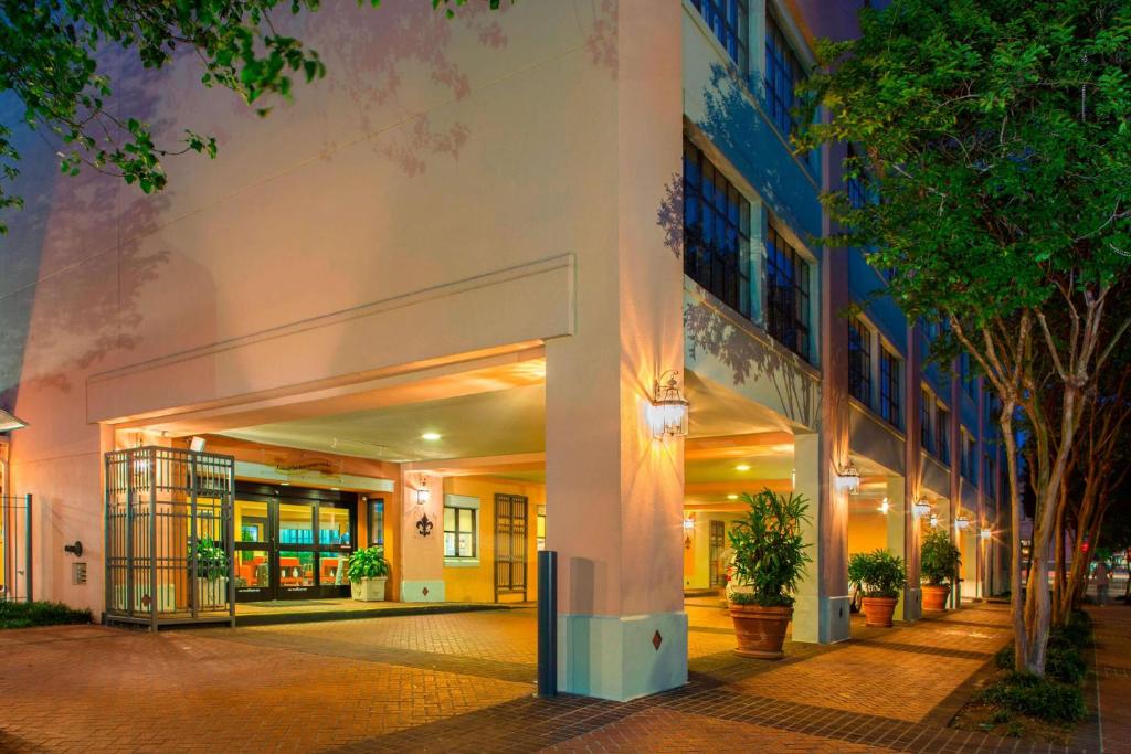 a large building with trees in front of it at Sonesta ES Suites New Orleans Convention Center in New Orleans