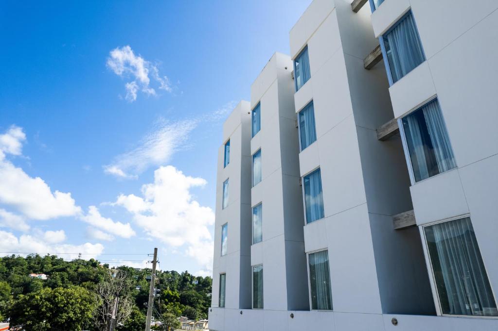 um edifício branco com um céu azul ao fundo em Royal Delonix em Penuelas