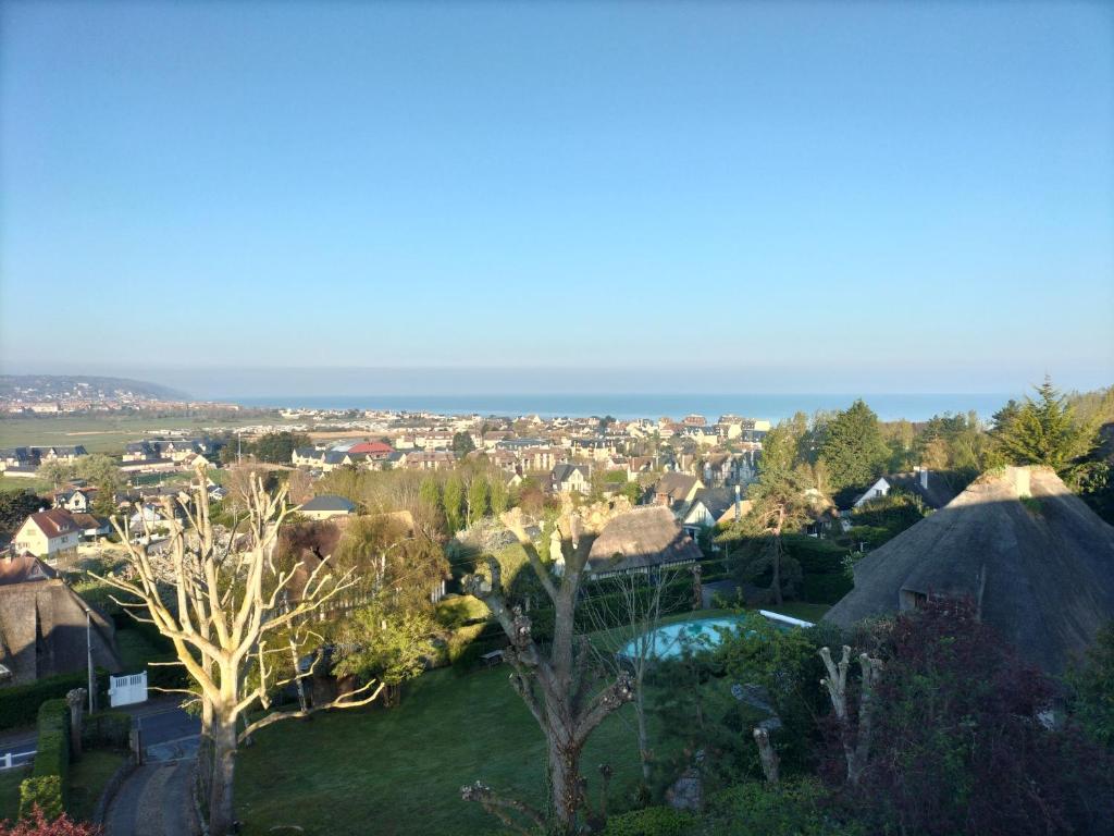 an aerial view of a town with trees and houses at Joli studio neuf vue mer proche Deauville in Blonville-sur-Mer