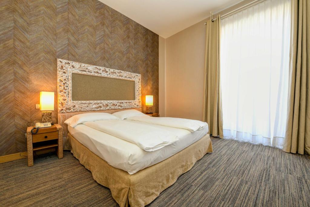 Uma cama ou camas num quarto em Hotel Flaminia