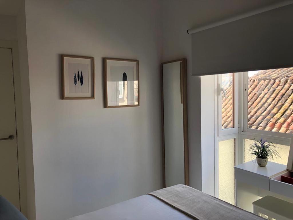 A bed or beds in a room at Holidays2Malaga Alta Street 1 bedroom High Speed WIFI