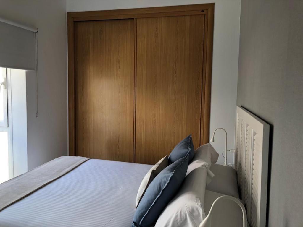 A bed or beds in a room at Holidays2Malaga Alta Street 1 bedroom High Speed WIFI