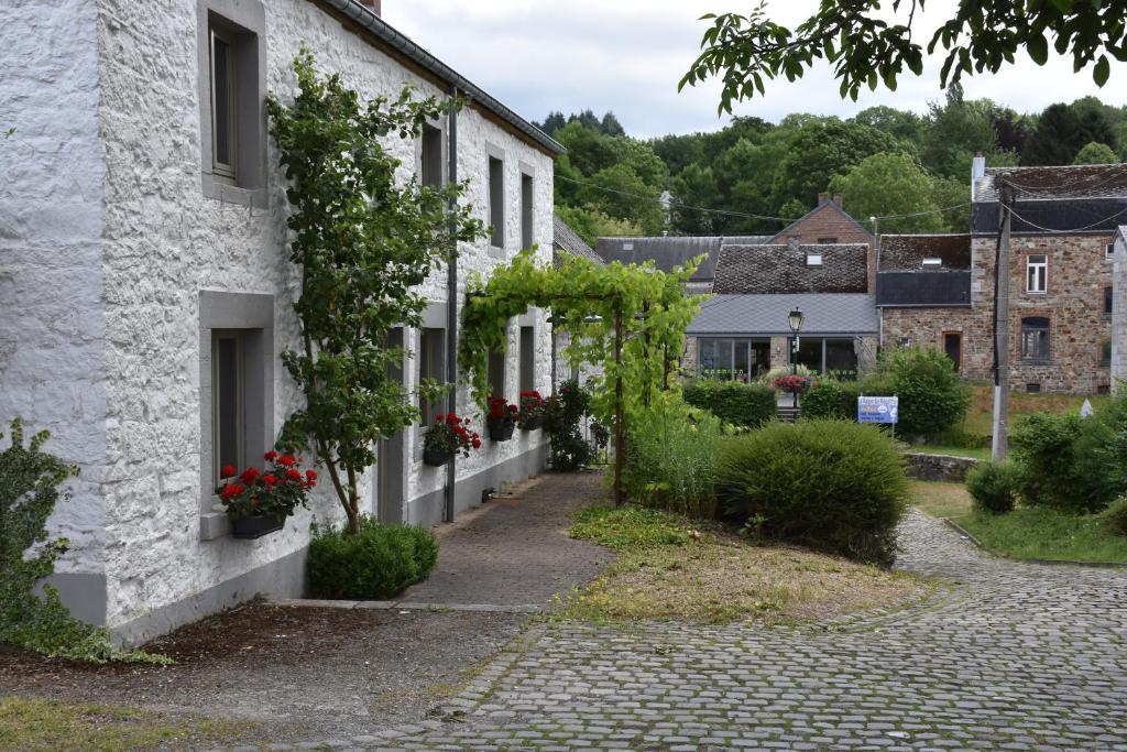 a cobblestone street in a village with white houses at les maisons blanches in Weris