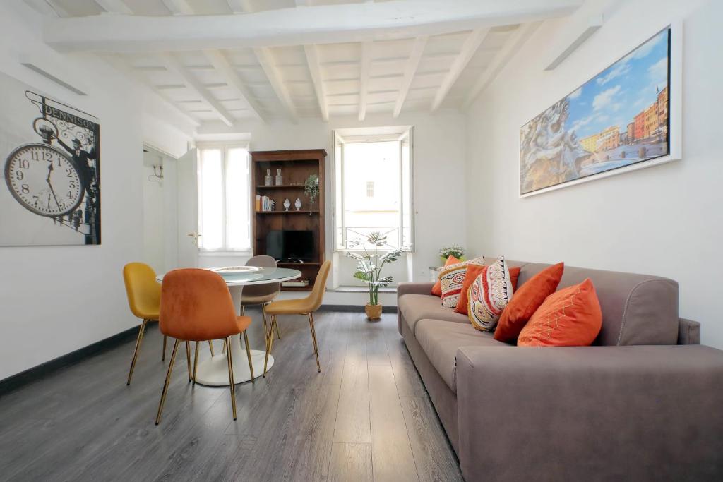 a living room with a couch and a table at Corallo Apartment in Rome