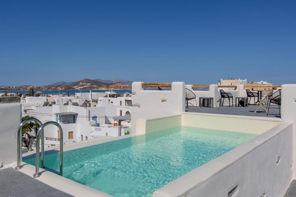 a pool on the roof of a house with white buildings at Ampelos Residence Naxos in Naxos Chora