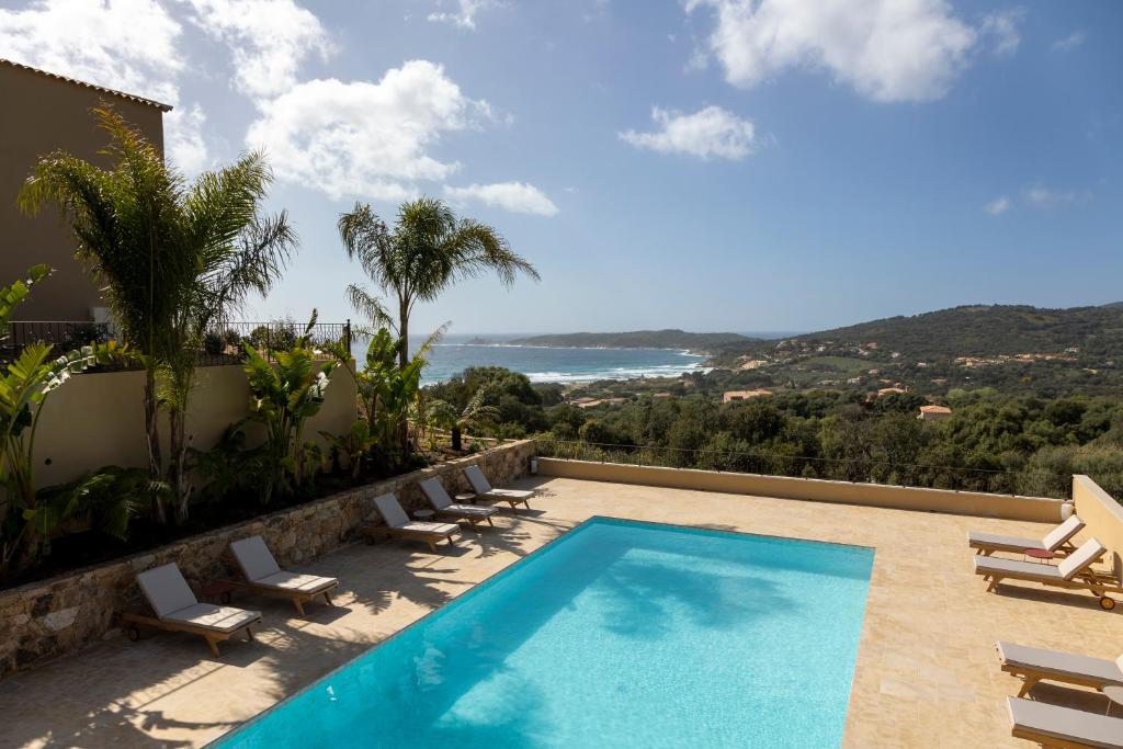 a villa with a swimming pool and a view of the ocean at Résidence Omigna in Cargèse