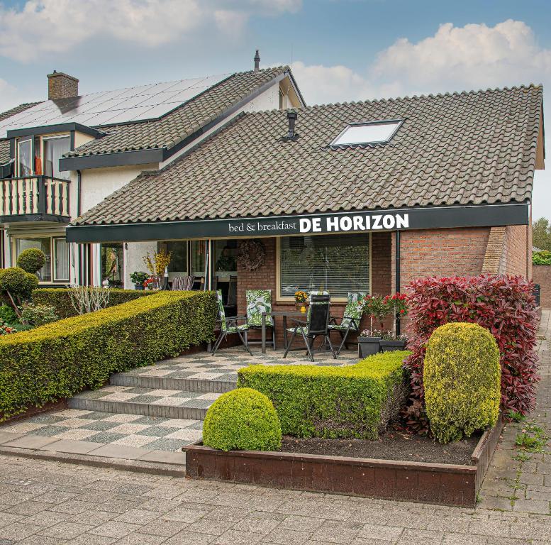 a house with a sign that reads just realized de horion at B&B De Horizon in Urk