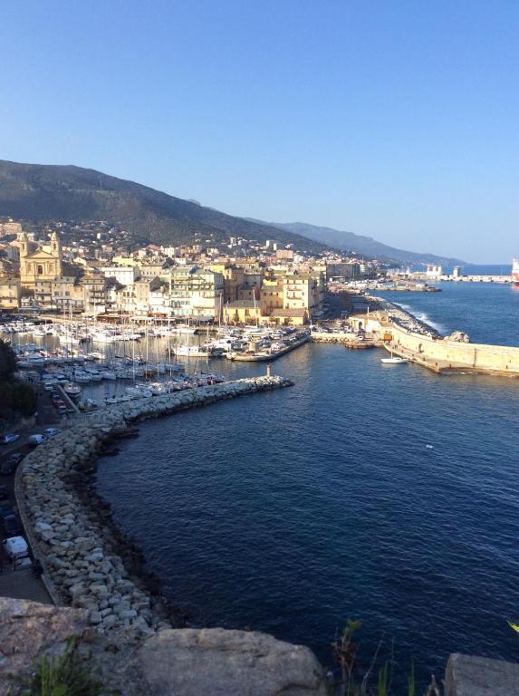 a view of a harbor with boats in the water at Centre historique bastia in Bastia