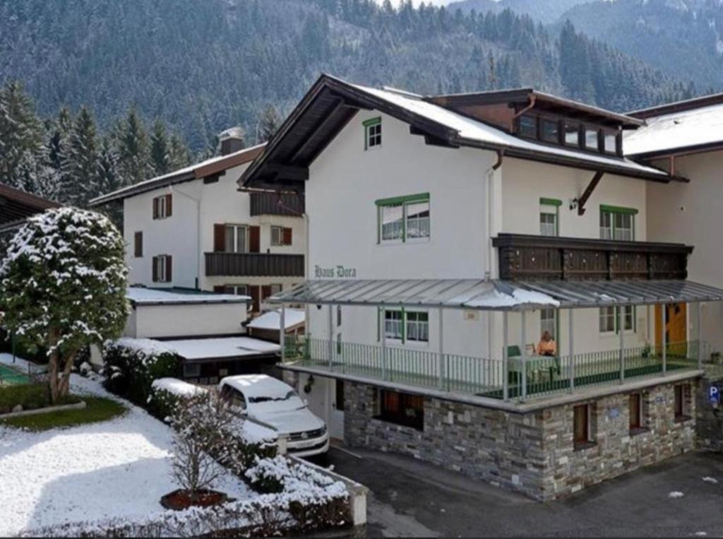 a large white house with snow on the ground at Haus Dora Apartment 3 Ahorn in Mayrhofen