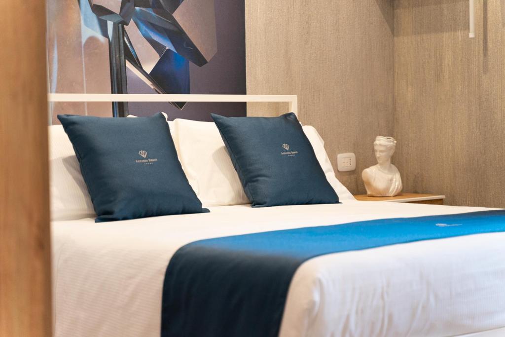 Postel nebo postele na pokoji v ubytování Antonio Busco rooms