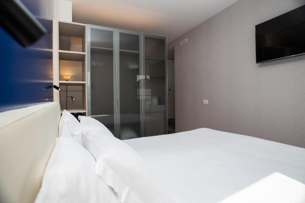 Postel nebo postele na pokoji v ubytování Padova Suites C20