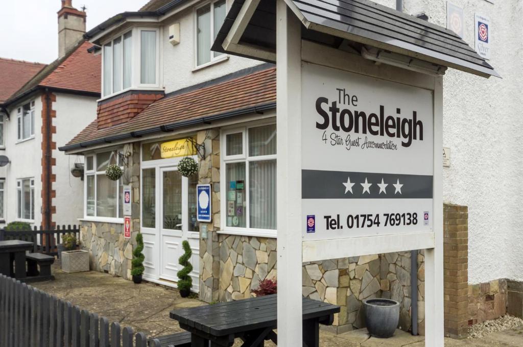 a sign in front of a building with a bench at Stoneleigh Hotel in Skegness