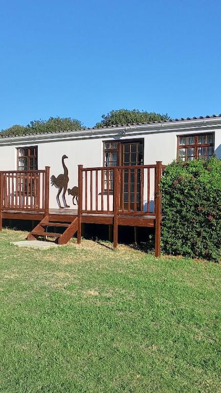 a building with a monkey mural on the side of it at Faithlands Self-Catering Cottages in Port Elizabeth
