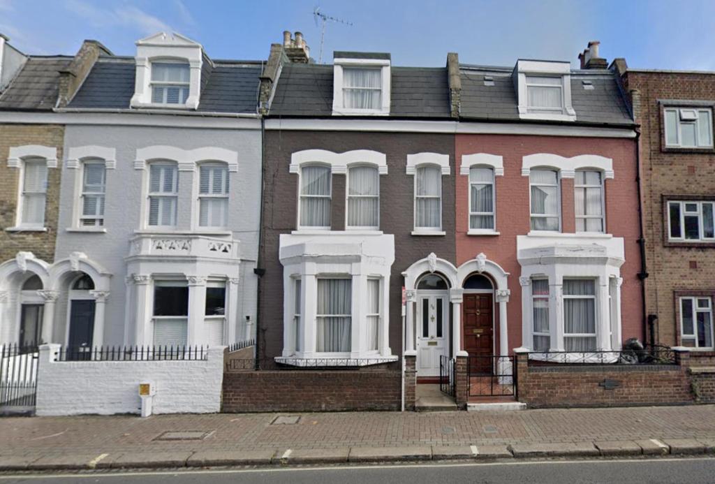 a row of houses on a city street at Cheerful 4 Bedroom Victorian house with back courtyard in London