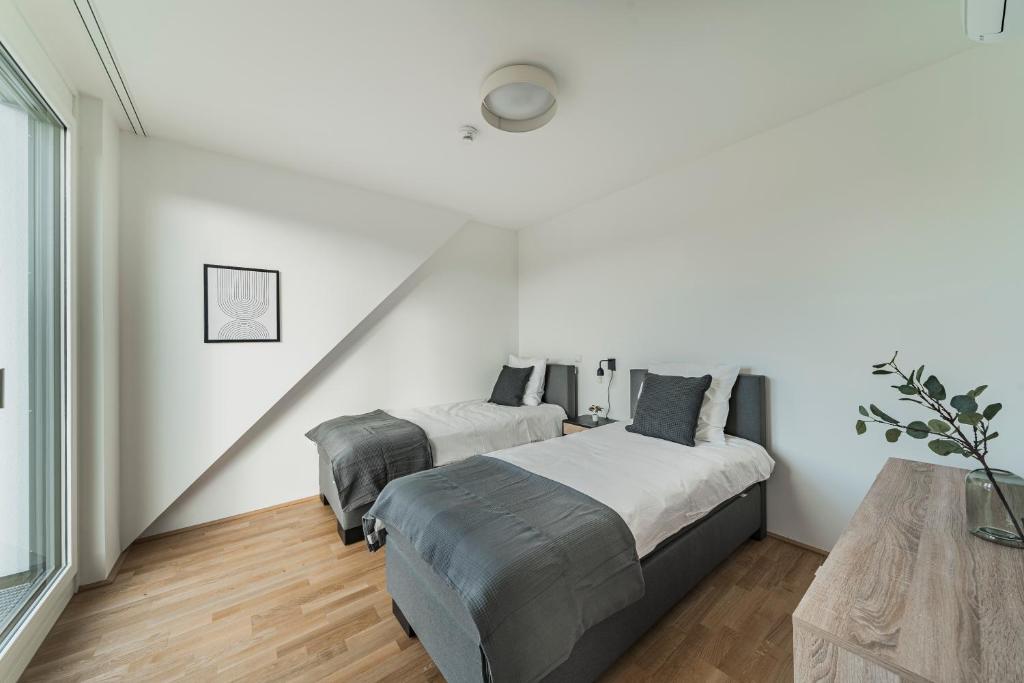 Łóżko lub łóżka w pokoju w obiekcie Arbio I Liv's Place Lux Apartments