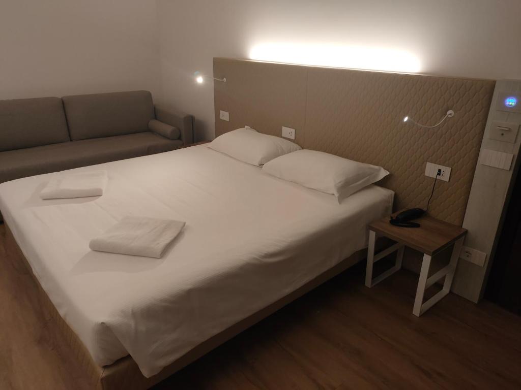 Postel nebo postele na pokoji v ubytování Albergo Baschera
