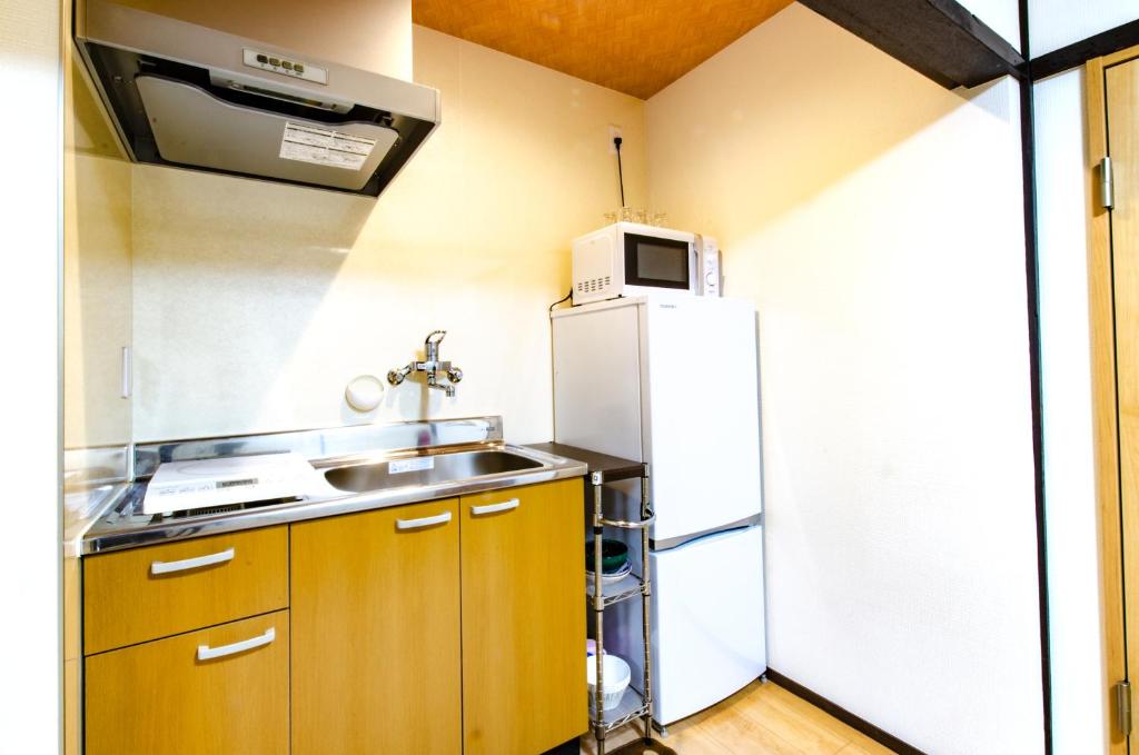Kuchyň nebo kuchyňský kout v ubytování 桜の宿千本 two rooms two toilets