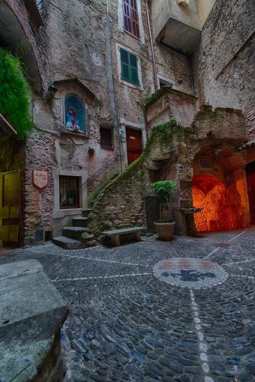an old stone building with a person in a window at BB Le Gemme in Dolceacqua