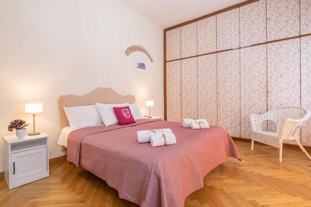 a bedroom with a bed with two towels on it at LH-Casa Dora in Pisa