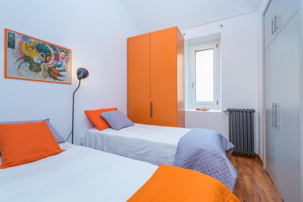 A bed or beds in a room at San Salvario Family Apartment by Wonderful Italy