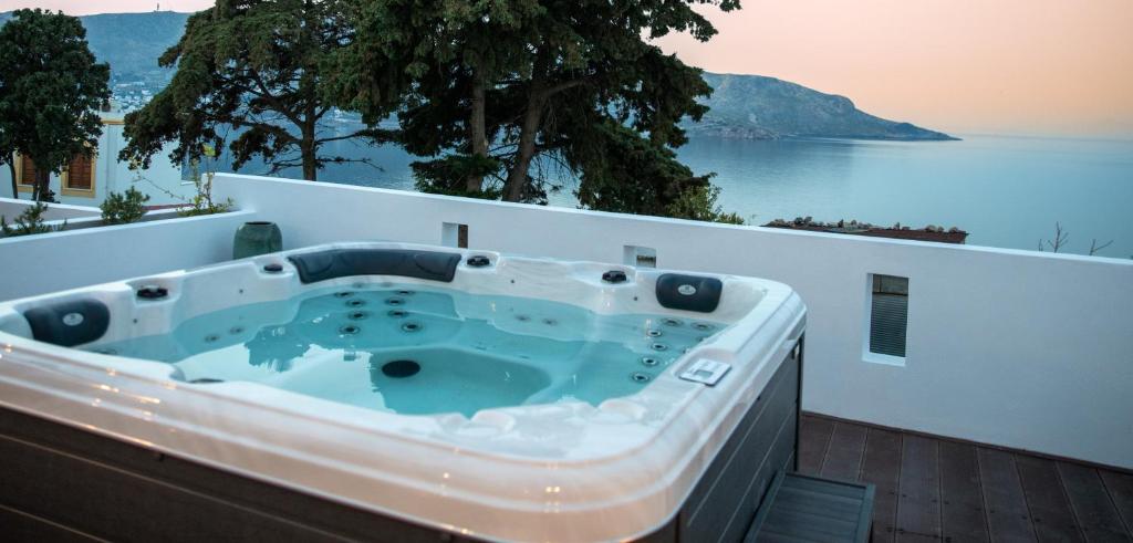 a bath tub on a balcony with a view of the water at Sunny Bay in Agia Marina