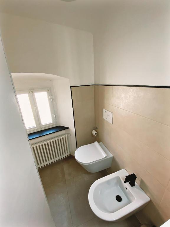 a small bathroom with a toilet and a sink at Appartamento Villa Cristina in Genoa