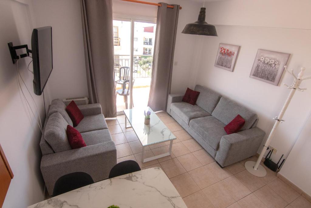 a living room with two couches and a table at Amelia Two Bedroom Apartment - 202 in Paphos City