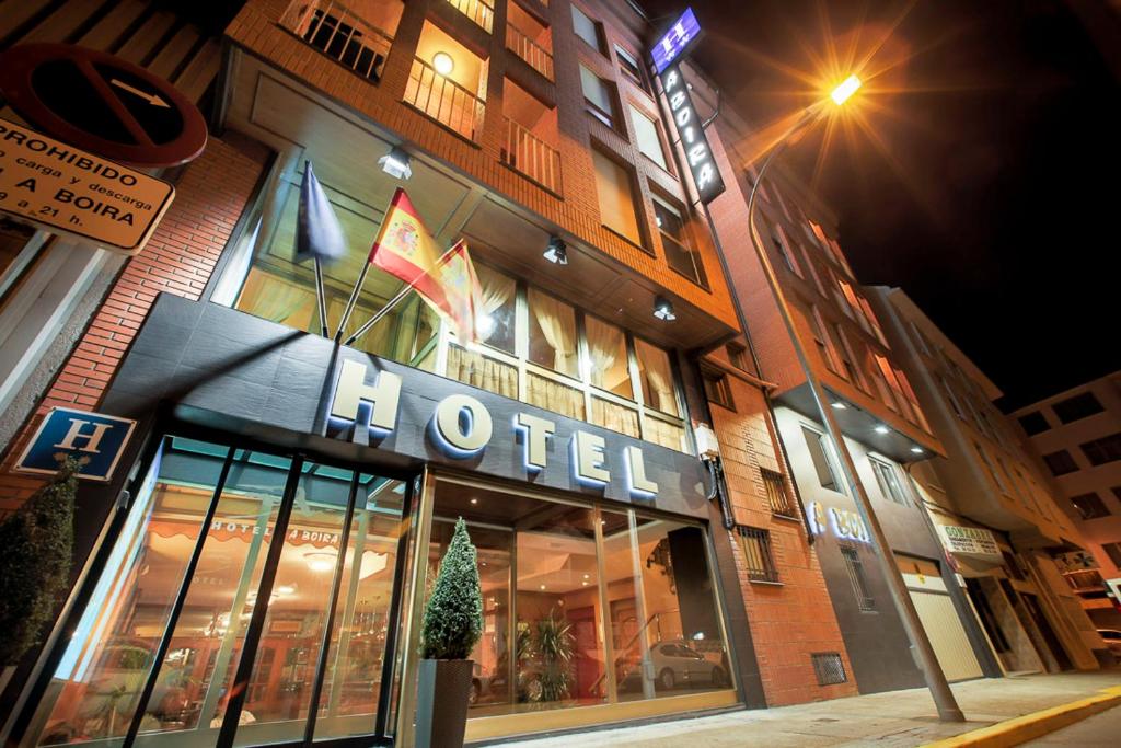 a store front of a hotel at night at Hotel A Boira in Jaca