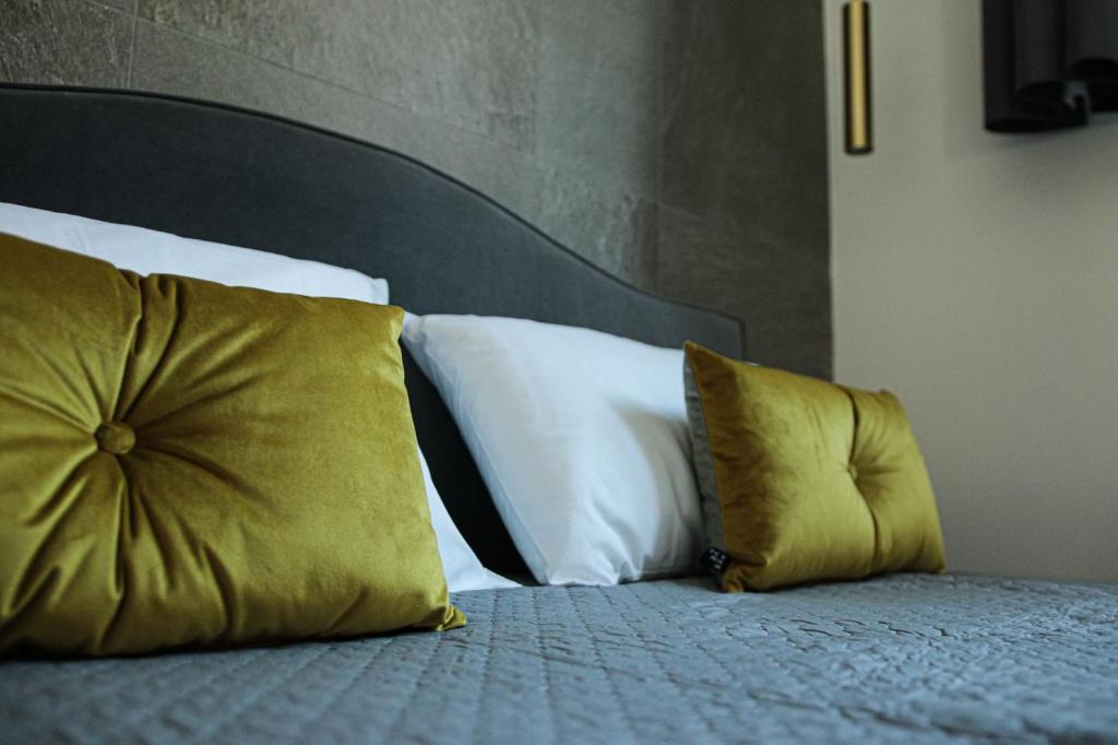 a bed with two pillows on top of it at BeTurin in Turin