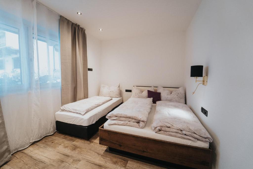 Postel nebo postele na pokoji v ubytování Apartklusiv Kaltenbach